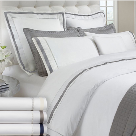 Eastman Heritage elegant and luxury bedding featuring white and gray embroidered linens with layers of natural comfort.