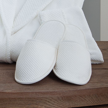 Eastman Heritage white waffle knit spa slippers and robe providing layers of natural comfort and an elegant and luxury feel.